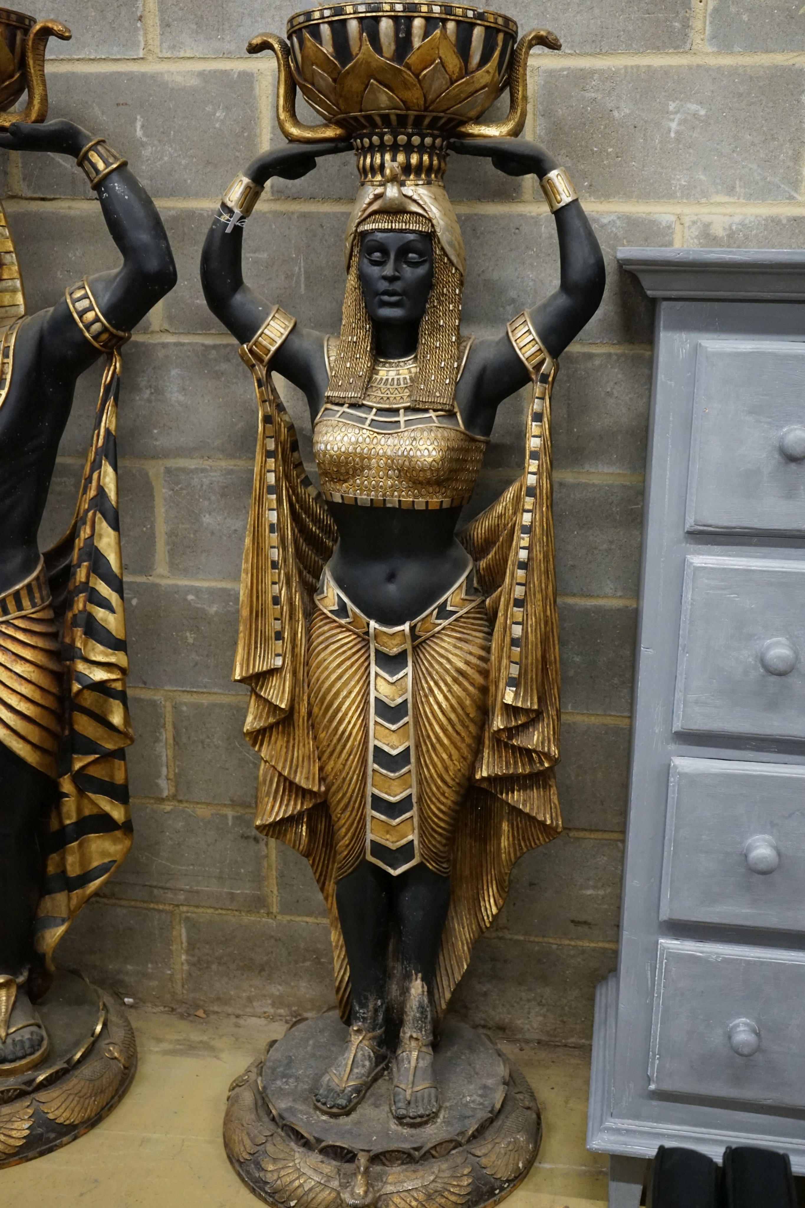A pair of composition Egyptian style figural planters, height 185cm